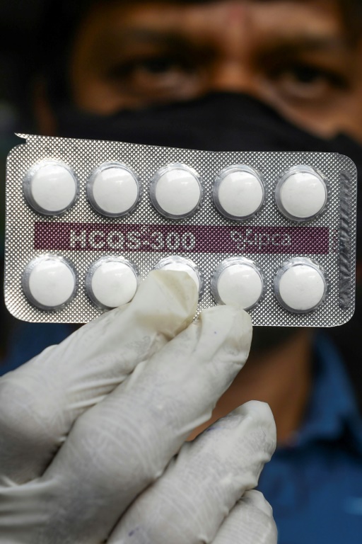 farmacêutico exibindo comprimidos de hidroxicloroquina em sua loja em Hyderabad, na Índia