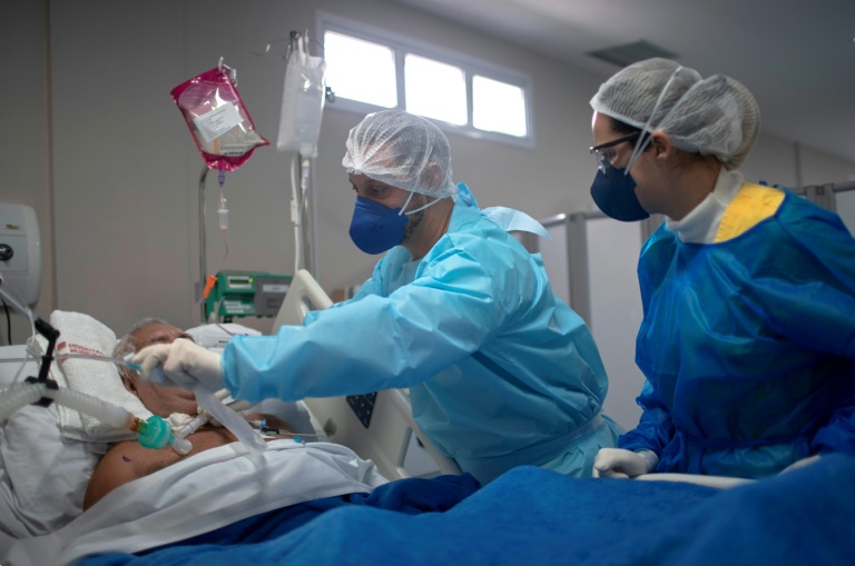 O enfermeiro Hans Bossan verifica um paciente infectado com COVID-19 na Unidade de Terapia Intensiva (UTI) do Hospital Público Doutor Ernesto Che Guevara, em Maricá, Rio de Janeiro, em 6 de junho de 2020