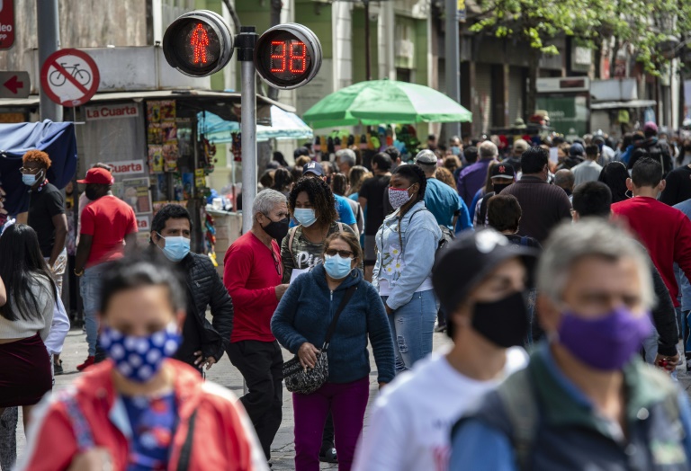 Pedestres caminham com máscara por rua movimentada no centro de Santiago, no Chile