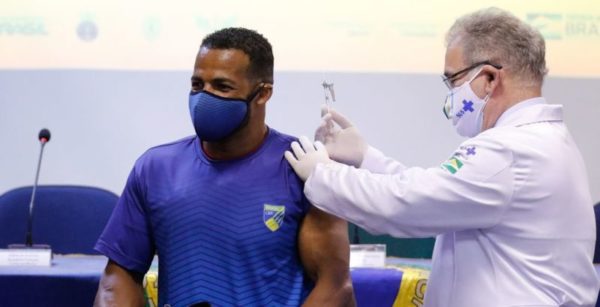 O ministro da Saúde Marcelo Queiroga vacina o atleta paralímpico do remo Michel Pessanha, que disputará os jogos de Tóquio, no Japão