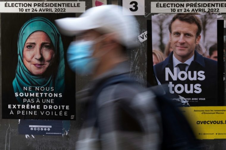 Ao fundo: intervenção feita pelo artista Jaeraymie no pôster de campanha de Marine Le Pen, ao lado do cartaz de Emmanuel Macron, em Paris