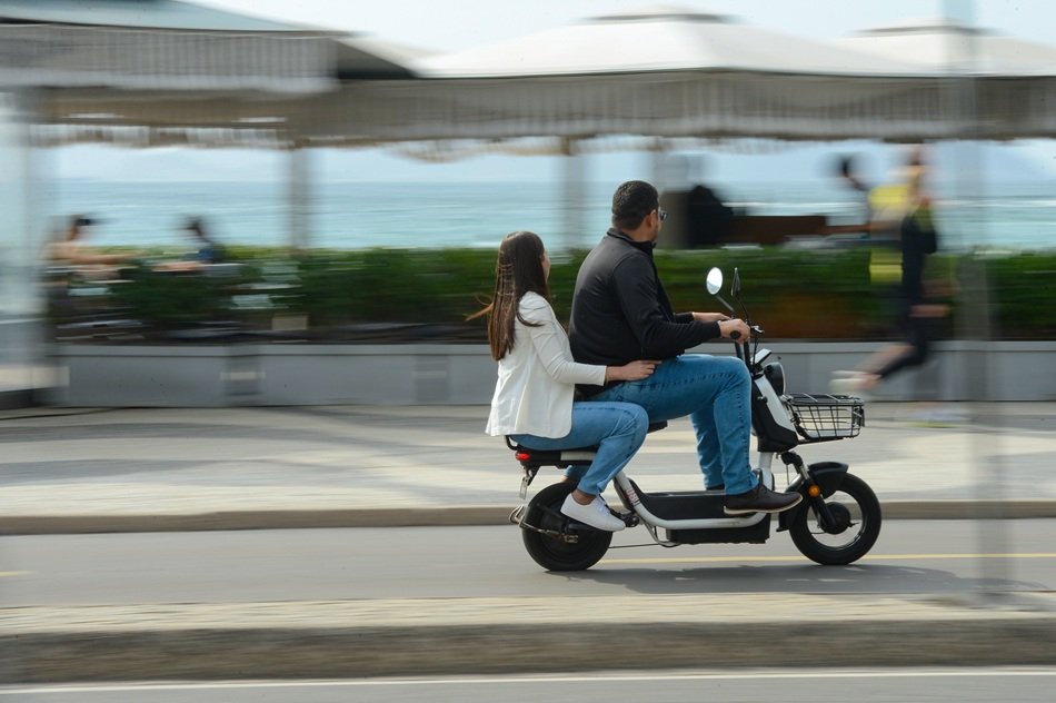Circulação de ciclomotor pela orla do Rio de Janeiro.