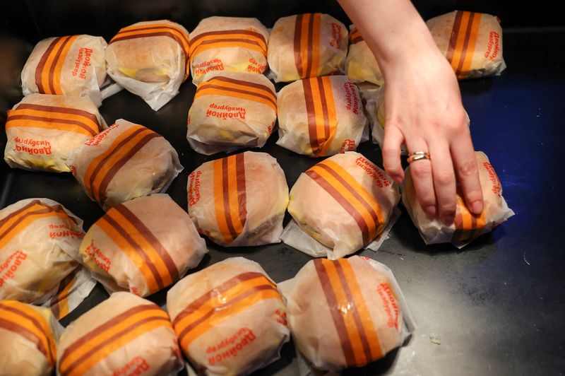 Funcionário coloca hambúrgueres em novo restaurante "Vkusno & tochka", inaugurado após a saída da McDonald's Corp do mercado russo, em Moscou, na Rússia. 12/06/2022. REUTERS/Evgenia Novozhenina/File Photo