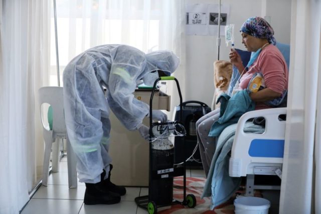 Agente de saúde trata paciente em hospital de Johanesburgo, na África do Sul